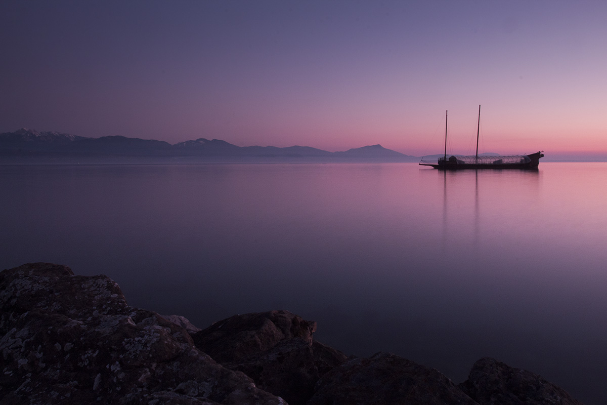 A boat on Lake Geneva during sunset outside Morges Switzerland